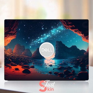 Puede incluir: Una piel para portátil con una escena de cielo nocturno estrellado sobre una masa de agua con acantilados rocosos. El logotipo de Dell es visible en el centro de la piel.
