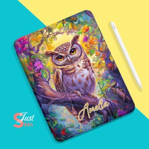 May include: A colorful iPad case with a painting of an owl perched on a branch with flowers. The name "Amelia" is written in gold lettering on the case.