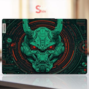 May include: A Lenovo laptop skin featuring a detailed, green, robotic demon face with red eyes and horns. The design is set against a dark background with red and green circuit-like patterns. The word "Lenovo" is printed on the side.