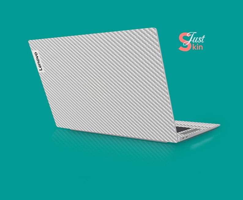 May include: A white laptop with a carbon fiber pattern skin. The laptop has the Lenovo logo on the back.