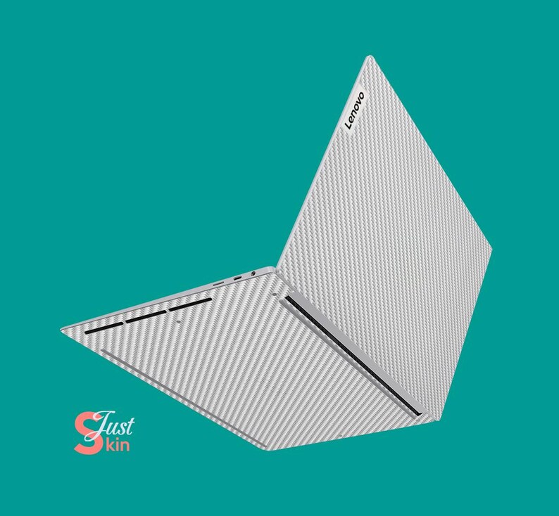 May include: A white laptop with a carbon fiber pattern on the lid. The laptop is open and the lid is tilted back. The Lenovo logo is visible on the lid.