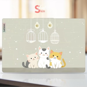 May include: A laptop skin with a light grey background featuring three cartoon cats. The cats are white, grey, and orange. The skin has the word "Lenovo" printed on the left side. The background has a subtle brick pattern and a few small white dots. There are three birdcages with white bars hanging from the top of the image.