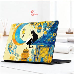 May include: Laptop skin featuring a whimsical illustration of a black cat perched on a rooftop under a crescent moon. The design incorporates yellow, blue, and white colors with hanging lanterns and floral accents. The text "Just Skin" is visible.