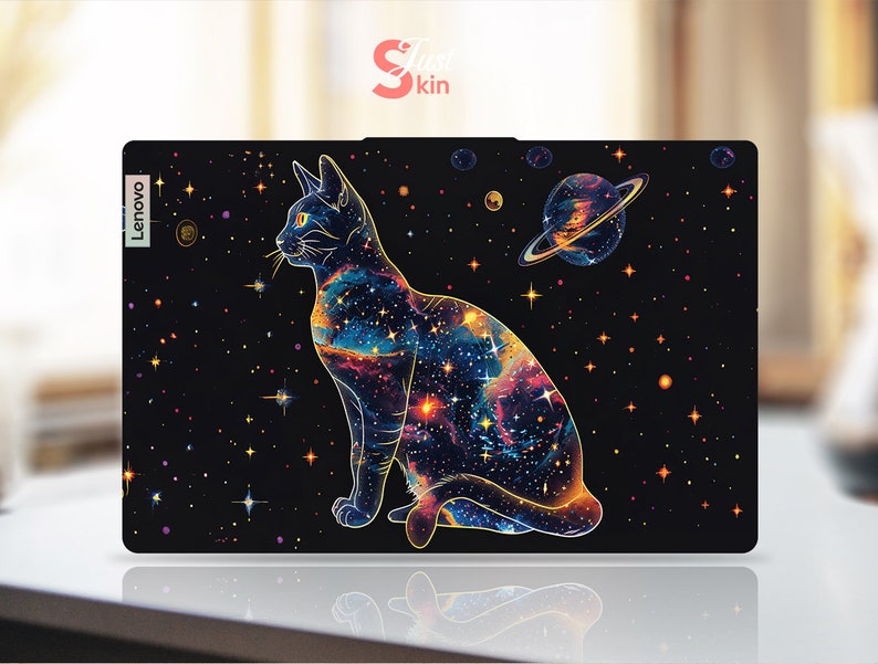 May include: A black laptop skin with a galaxy design featuring a cat with a starry body and a planet with rings. The text "Lenovo" is on the left side of the skin.
