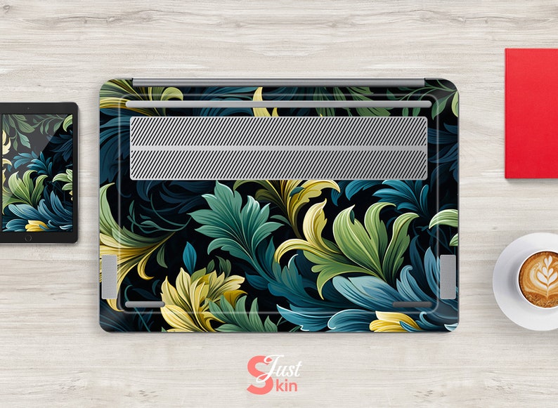 May include: Laptop skin with a dark background and a floral pattern in shades of green, blue, and yellow. The design features intricate leaves and swirls.
