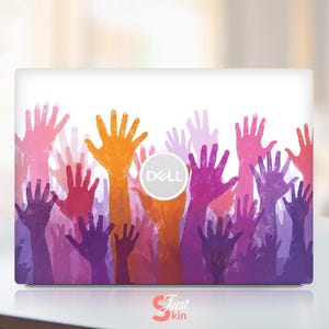 May include: A laptop skin featuring a watercolor design of raised hands in shades of pink, orange, purple, and red. The Dell logo is visible. The Just Skin logo is at the bottom.