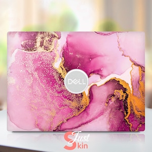 May include: Pink and gold marble laptop skin with the Dell logo.