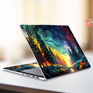 K&ouml;nnte beinhalten: Ein Laptop mit einem farbenfrohen abstrakten Design einer Waldszene mit Sonnenuntergang. Das Design zeigt eine Vielzahl von Farben, darunter Blau, Gr&uuml;n, Gelb, Orange und Rot. Der Laptop ist ge&ouml;ffnet und der Bildschirm ist sichtbar. Der Laptop hat das Lenovo-Logo an der Seite.