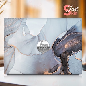 Könnte beinhalten: Laptop-Skin mit Marmordesign in Grau-, Schwarz- und Goldtönen. Das HP-Logo ist in der Mitte sichtbar. Die Worte "Just Skin" befinden sich in der oberen rechten Ecke.