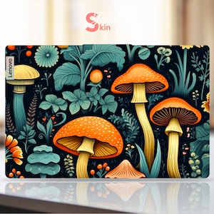 May include: A laptop skin with a dark background and a colorful pattern of mushrooms and foliage. The skin features a variety of mushrooms in shades of orange, yellow, and red, surrounded by green leaves and flowers. The text "Lenovo" is visible in the upper left corner of the skin.