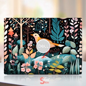 May include: A laptop skin featuring a colourful floral and bird design on a black background. The design includes a bird with orange and yellow feathers, green leaves, and pink flowers. The Dell logo is visible on the skin.