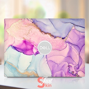 May include: A laptop skin with a pink, purple, and blue abstract marble design with gold accents. The Dell logo is visible on the skin.