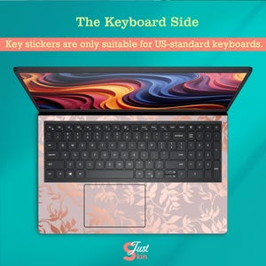 May include: A laptop with a keyboard skin featuring a floral design in rose gold and light pink. The text "The Keyboard Side" and "Key stickers are only suitable for US-standard keyboards" are visible. The brand logo "Just kin" is at the bottom.