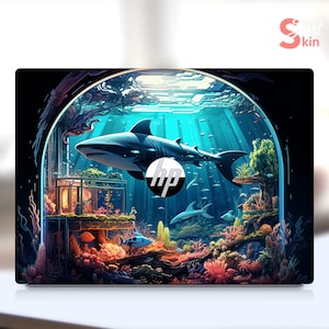 May include: A laptop skin with a colorful underwater scene featuring a shark, coral reefs, and a fish. The HP logo is visible in the center of the image.