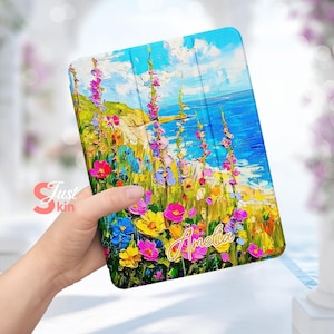 May include: A colorful floral design with a blue ocean and sky background. The design is printed on a tablet case with the name "Amelia" written in gold script.