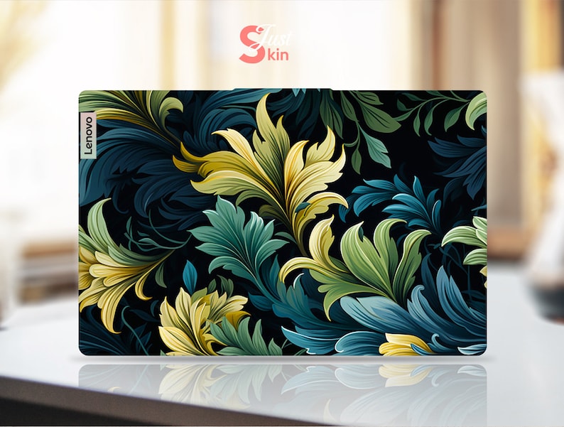 May include: A laptop skin with a dark background and a floral pattern in shades of green, yellow, and blue. The Lenovo logo is visible in the top left corner.