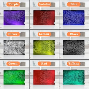 May include: Nine laptop skins in a range of colours: purple, dark red, blue, silver, lemon, black, green, red, and Tiffany. Each skin has a textured, swirling pattern. The colours are vibrant and the designs are consistent across all the skins.