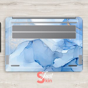 May include: A blue and gold laptop skin with a marble-like design. The skin has a subtle shimmer and is perfect for adding a touch of elegance to your laptop.