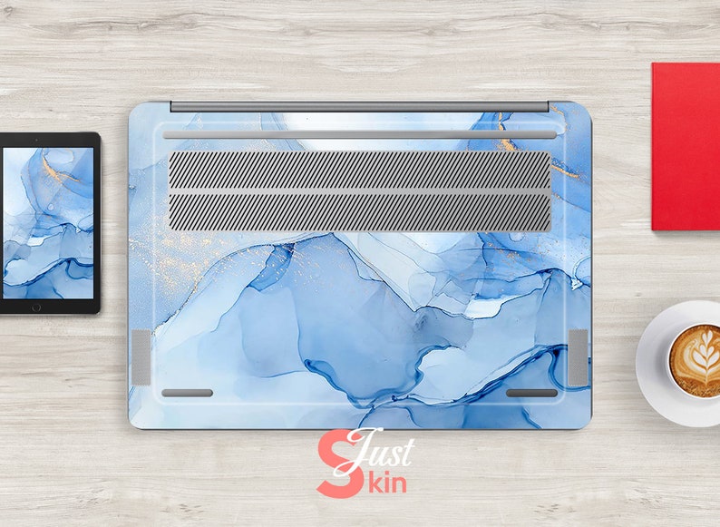 May include: A blue and gold laptop skin with a marble-like design. The skin has a subtle shimmer and is perfect for adding a touch of elegance to your laptop.