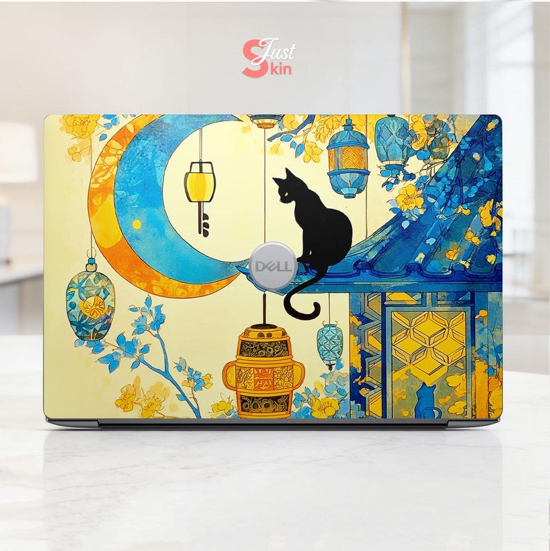 May include: Laptop skin featuring a whimsical design with a crescent moon, lanterns, and a black cat silhouette. The skin has a yellow and blue color scheme with floral accents and the Dell logo.