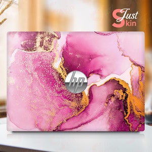 May include: Pink and gold marble laptop skin with a HP logo in the center.
