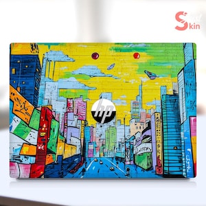 May include: A laptop skin featuring a vibrant cityscape design with graffiti-style art. The design includes colorful buildings, a yellow sky, and the HP logo. The overall aesthetic is urban and artistic.