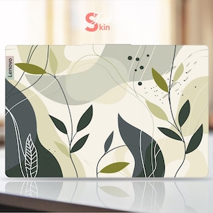 May include: A laptop skin with an abstract design featuring green leaves and white lines on a cream background. The skin has the word "Lenovo" printed on the left side.