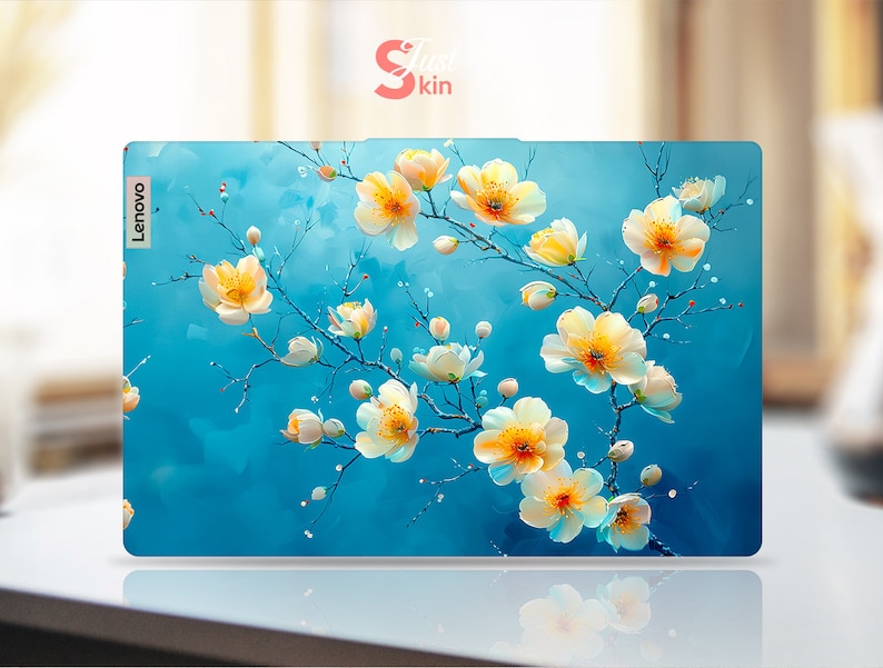 May include: A blue laptop skin with a floral design featuring white flowers with yellow centers. The Lenovo logo is visible in the top left corner.