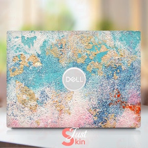 May include: A laptop skin with a blue, white, and gold abstract design. The skin has a textured look and features a gold foil effect. The Dell logo is visible in the center of the skin.