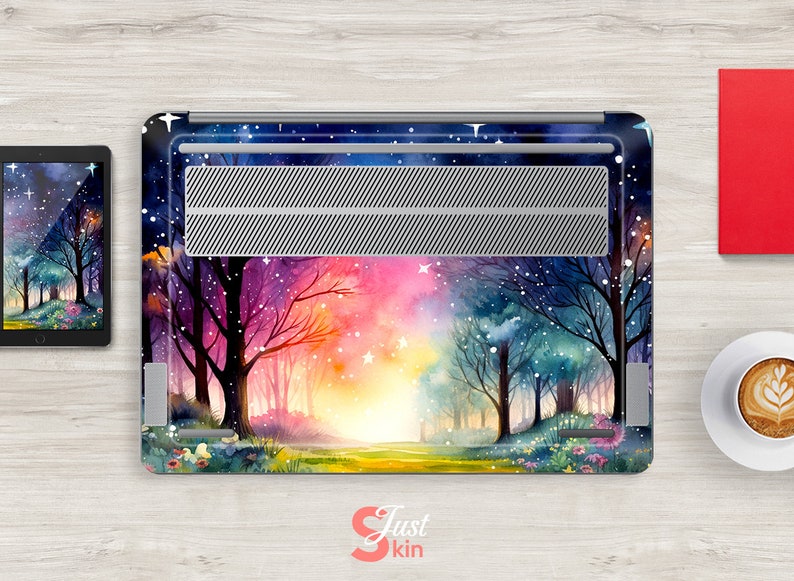 May include: A laptop skin with a watercolor design of a forest path with trees on either side. The path leads to a bright light at the end. The background is a dark blue sky with stars and a pink and orange sunset.