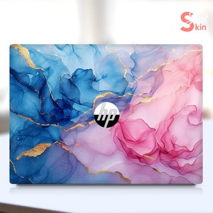 May include: Laptop skin with an abstract design featuring blue and pink watercolor-like swirls with gold accents. The skin has the HP logo in the center.