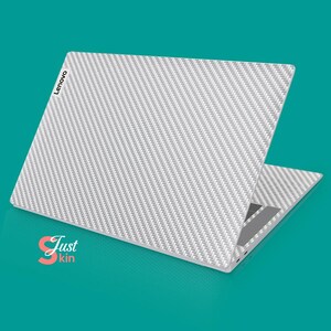 May include: A white laptop with a carbon fiber pattern on the lid. The Lenovo logo is visible on the lid. The laptop is open and the screen is facing away from the viewer.