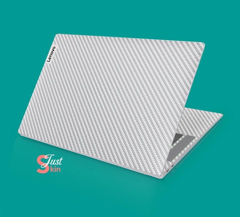 May include: A white laptop with a carbon fiber pattern on the lid. The Lenovo logo is visible on the lid. The laptop is open and the screen is facing away from the viewer.