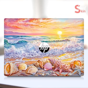 May include: A laptop skin with a sunset over the ocean and seashells on the beach. The skin features a blue and white ocean with a pink and orange sunset. The laptop skin also features a variety of seashells in different colors and sizes.