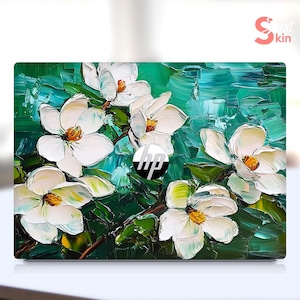 May include: A laptop skin with a green and white floral design. The flowers are white with yellow centers and are painted in a textured style. The HP logo is visible in the center of the skin.
