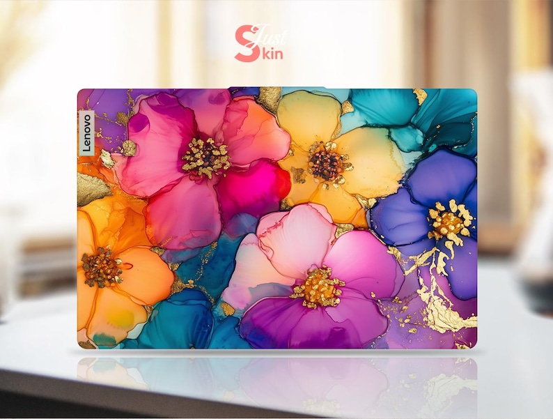 May include: A Lenovo laptop skin featuring a vibrant floral design. The artwork showcases large, abstract flowers in shades of pink, orange, yellow, blue, and purple, with gold accents. The "Skin Kin" logo is visible in the top right corner.