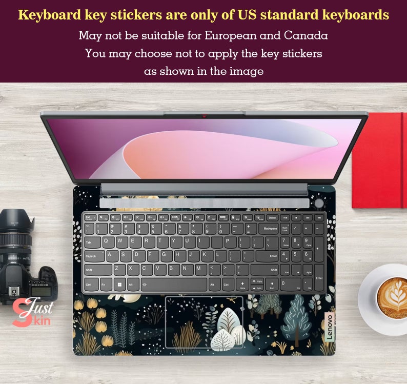 May include: Laptop with a decorative keyboard skin featuring a dark floral design with gold and white accents. The laptop is open, displaying the keyboard and screen. Text on the image states that the keyboard key stickers are only for US standard keyboards.