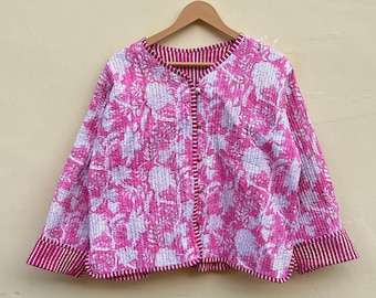 May include: A pink and white floral print quilted jacket with a button closure. The jacket has a relaxed fit and long sleeves.