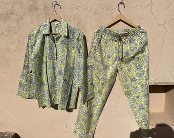 May include: A yellow and blue patterned pajama set with a long-sleeved shirt and pants.