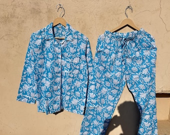 May include: A blue and white floral print pajama set with a button-up top and long pants.