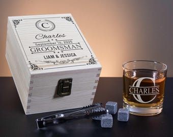 May include: A wooden box with a personalized inscription for a groomsman. The inscription reads "Charles, September 14, 2025, Groomsman, Liam & Jessica". The box has a hinged lid and a brass latch. A glass tumbler with the name "Charles" etched on it is next to the box.