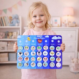May include: A blue and white evening routine chart with the text "GRACE'S Evening Routine" and "Today" in a heart. The chart has various illustrated icons for daily tasks. A young girl is holding the chart.