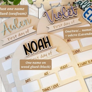 May include: Three wooden plaques with rounded tops, each with a different name written in decorative lettering. The names are Aiden, Noah, and Violet. Each plaque has a section for recording the child's first day, age, height, things they love, and what they want to be. The plaques are made of natural wood and have a rustic, handmade look.