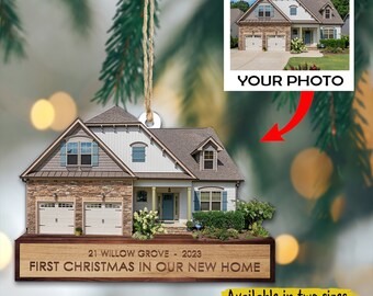 May include: A wooden Christmas ornament shaped like a house with a brown brick exterior, white siding, and a brown roof. The ornament has a personalized inscription that reads "21 WILLOW GROVE - 2023 FIRST CHRISTMAS IN OUR NEW HOME". The ornament is available in two sizes: 3.5 inches and 4.5 inches.