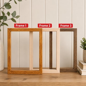 May include: Three rectangular wooden picture frames arranged in a row. Frame 1 is a medium-toned brown, Frame 2 is a light natural wood, and Frame 3 is a dark espresso brown. Each frame features a simple, clean-lined design with visible wood grain.