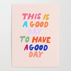 Op de afbeelding: Een roze achtergrond met de tekst "This is a good day to have a good day" in kleurrijke, omrande letters.