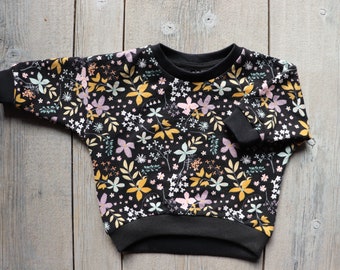 Lüddjen - trui/pullover oversized zwart met kleurrijke bloemen voor baby's en peuters