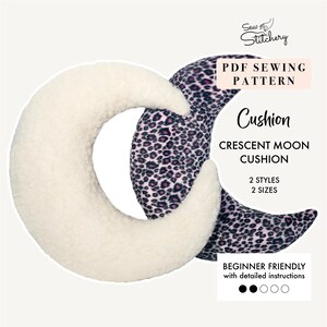 May include: PDF sewing pattern for a crescent moon cushion. The pattern includes two styles and two sizes. The image shows a white and a pink leopard print crescent moon cushion.