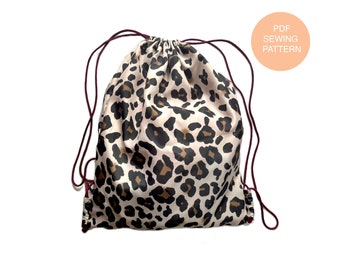May include: A drawstring bag with a leopard print design. The bag is made of a soft, silky fabric and has a maroon drawstring.