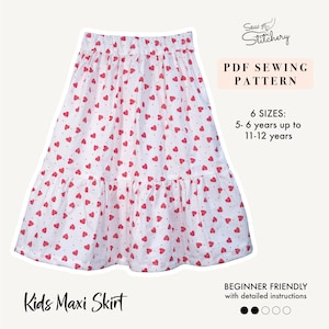 Peut inclure: Jupe longue pour enfants blanche ornée de cœurs rouges. La jupe a un ourlet à volants et une taille élastique. L'image comprend le texte : "Kids Maxi Skirt", "PDF Sewing Pattern" et "Beginner Friendly".